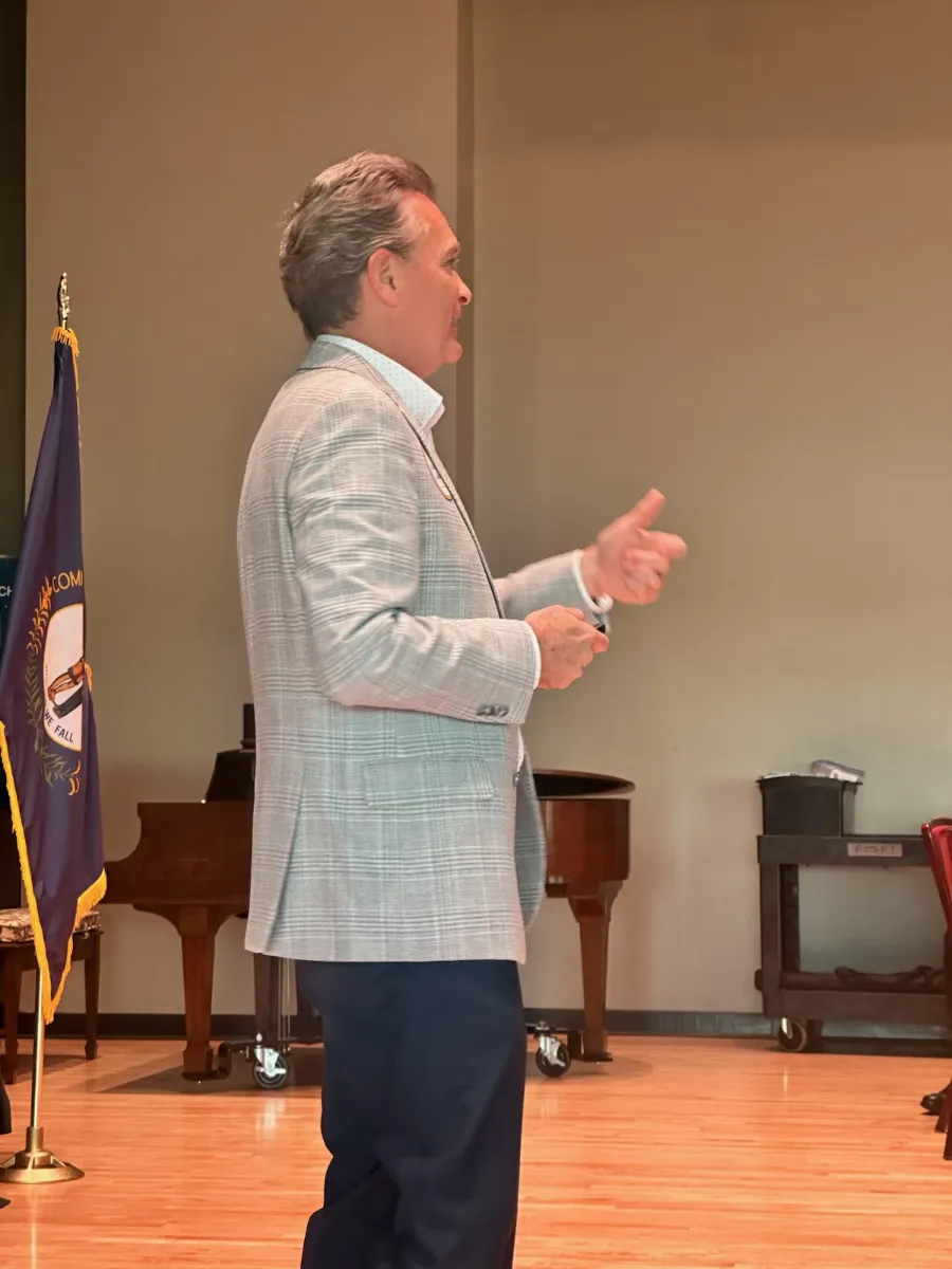Paul Chappell speaking on stage beside the Kentucky state flag