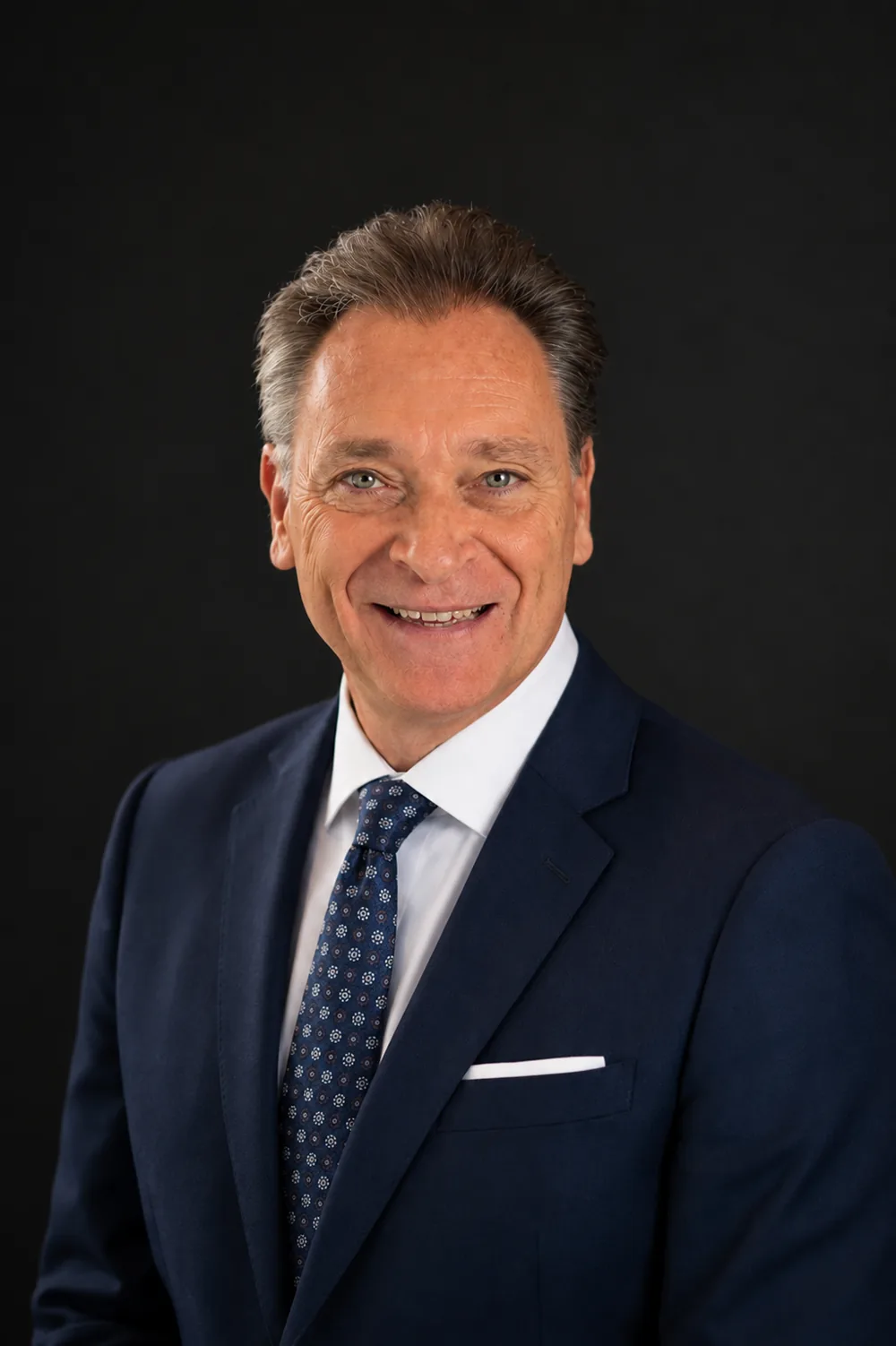 Paul Chappell headshot in a navy suit and tie